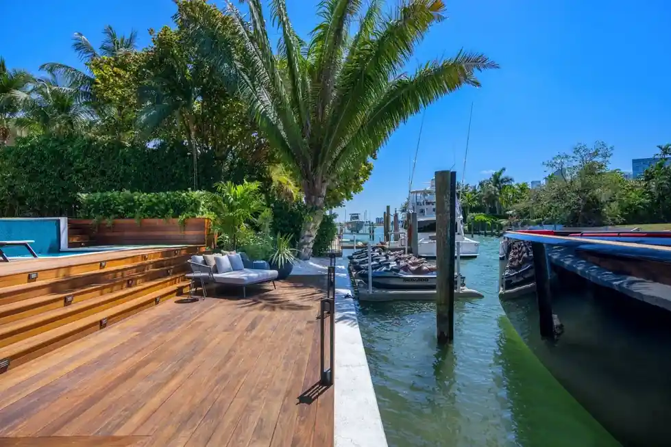 Casa Exumas waterfront dock with a timber deck beside the canal