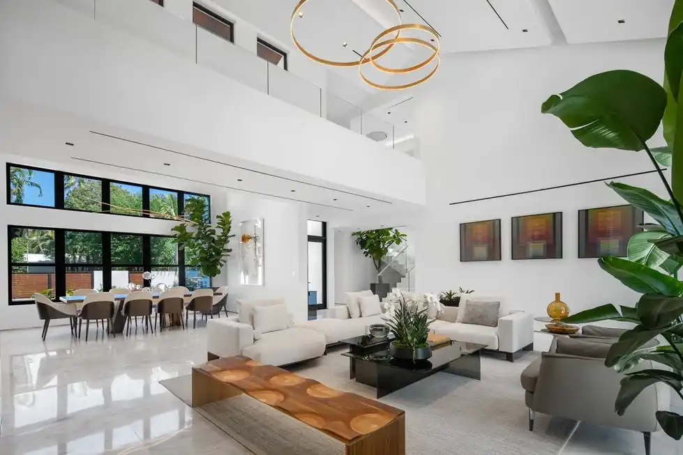 Casa Exumas double-height living room with gold ring pendant lights