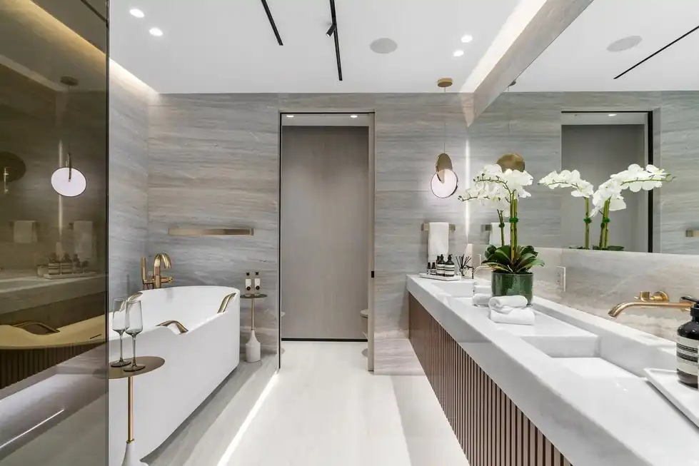 Lower PH66 bath with a freestanding tub, a ribbed wood vanity and a stone-clad wall