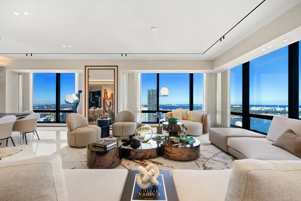 Lower PH66 lounge with cream sofas, a marble coffee table and city views