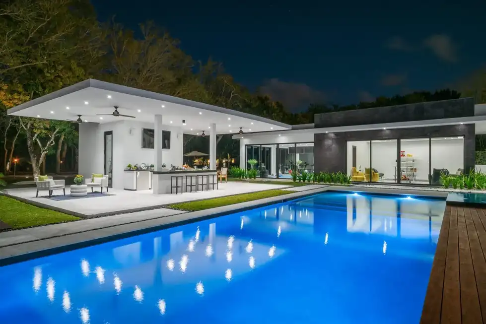 Casa Pinecrest pool and covered summer kitchen lit at night